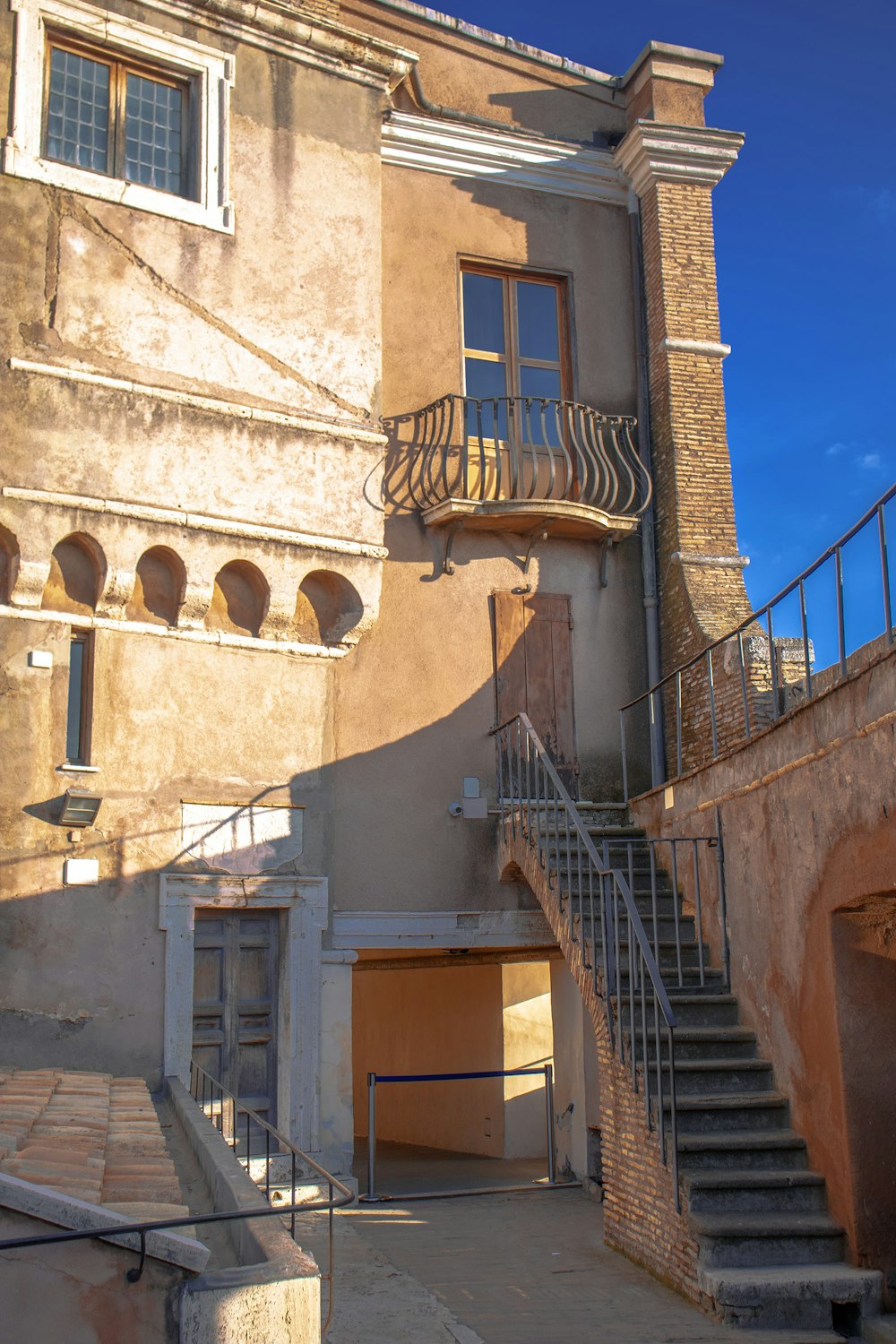 an old building with a staircase leading up to it