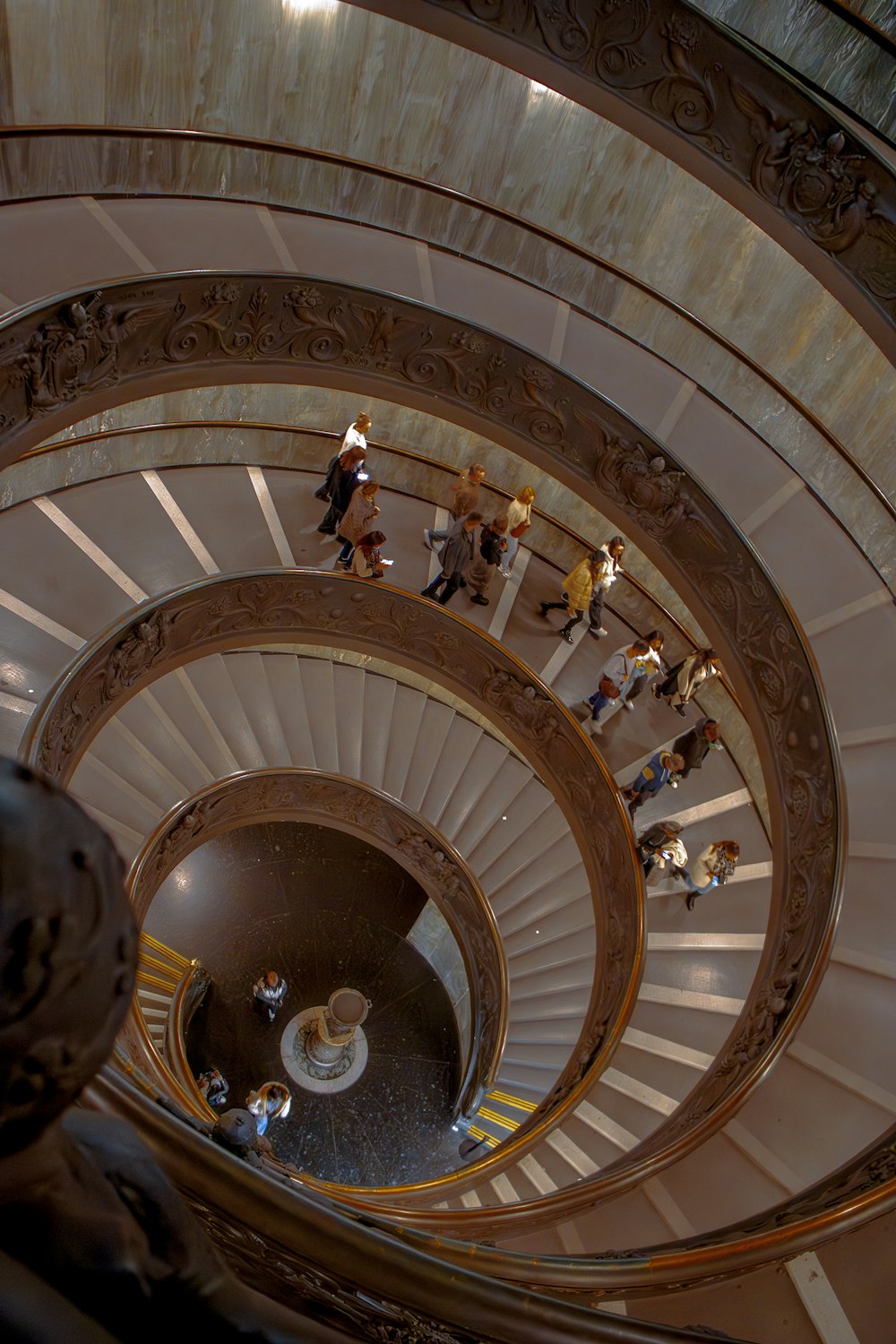 a group of people walking down a spiral staircase