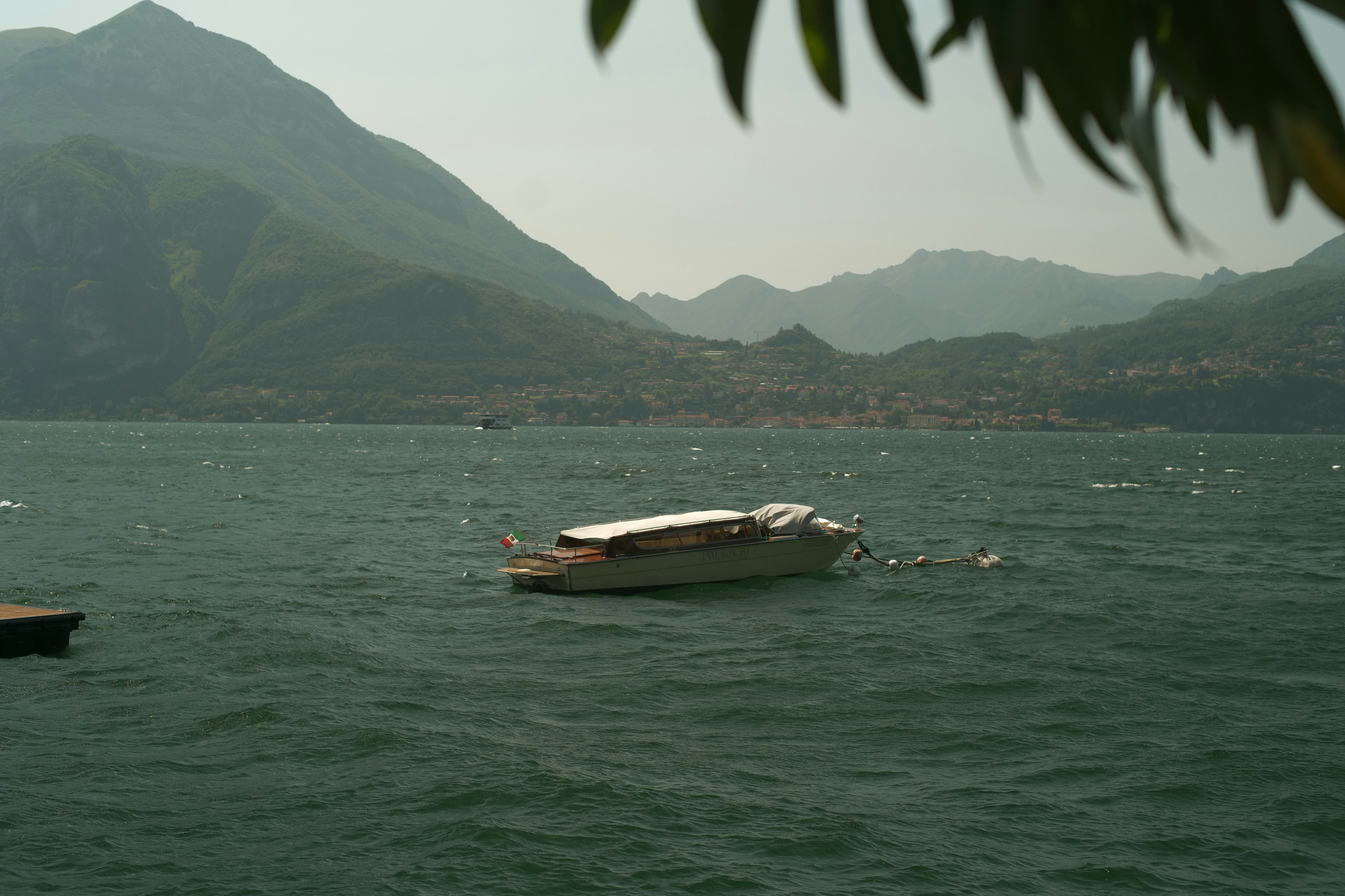 a small boat floating on top of a large body of water