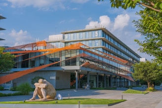 a large building with a sculpture in front of it