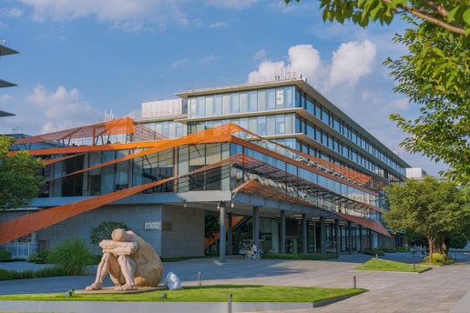 a large building with a sculpture in front of it