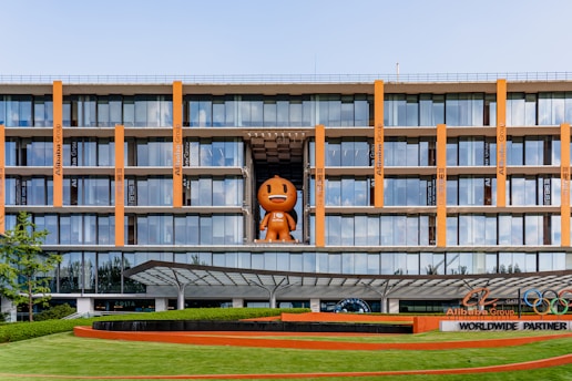 a large building with a giant orange object in the middle of it