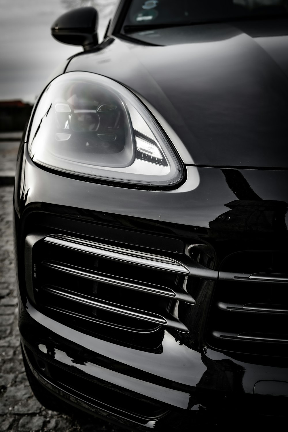 the front end of a black sports car