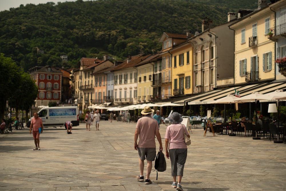 a couple of people that are walking down a street