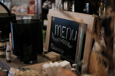 a menu sign sitting on top of a wooden table