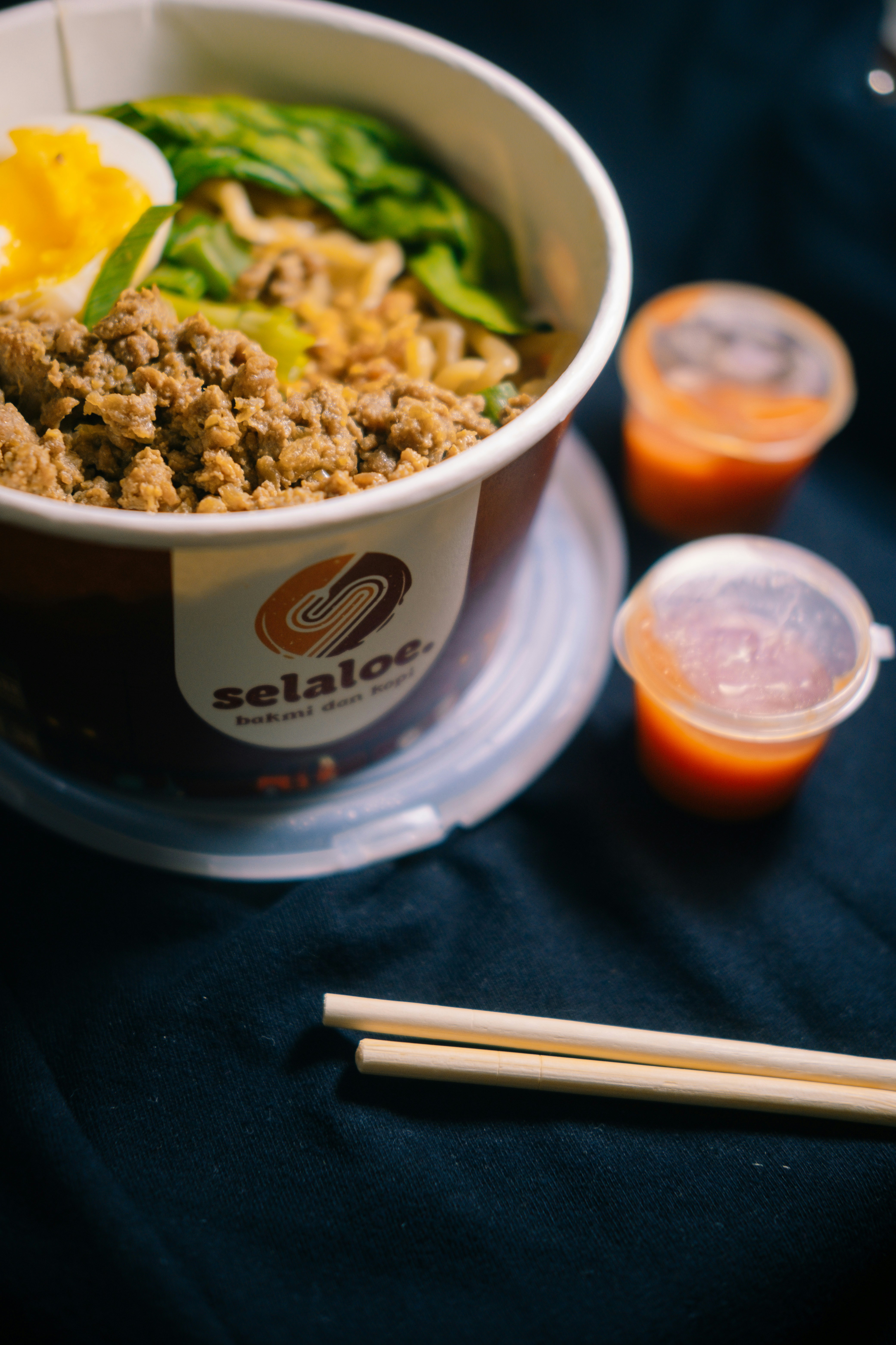 a bowl of food with chopsticks on a table
