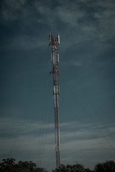 a tall cell phone tower sitting in the middle of a field