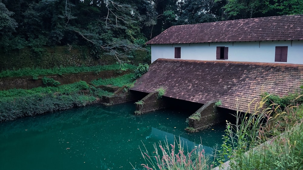 a small building sitting on the side of a river
