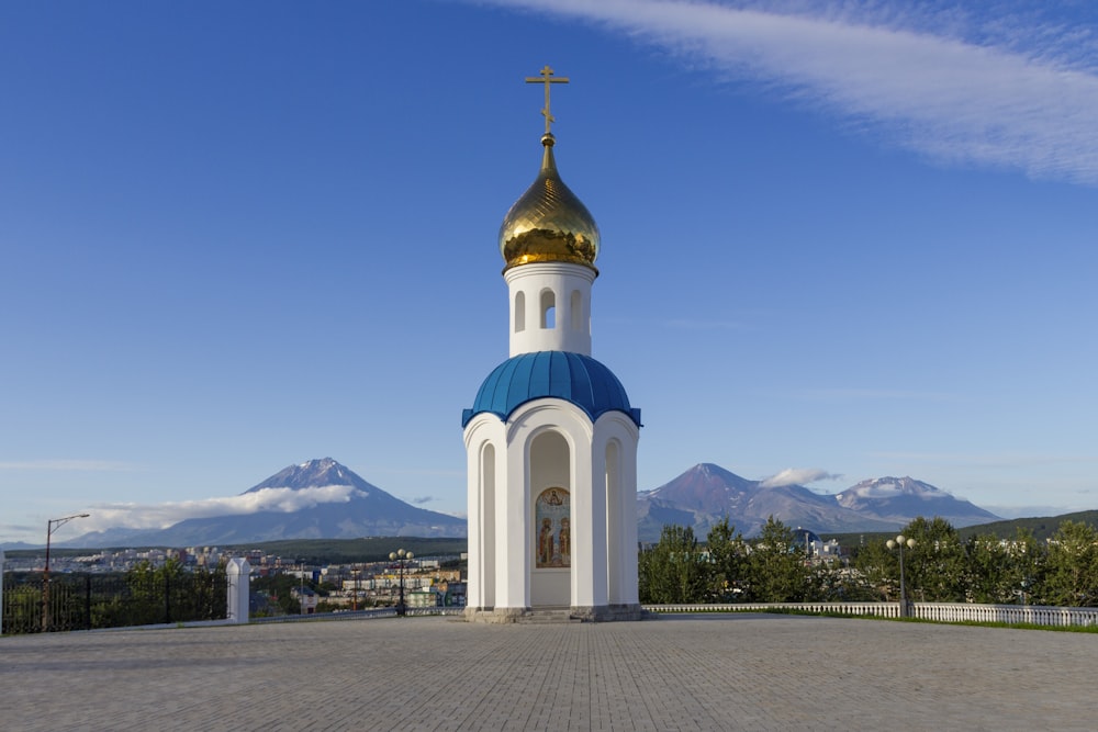 a white and blue church with a cross on top