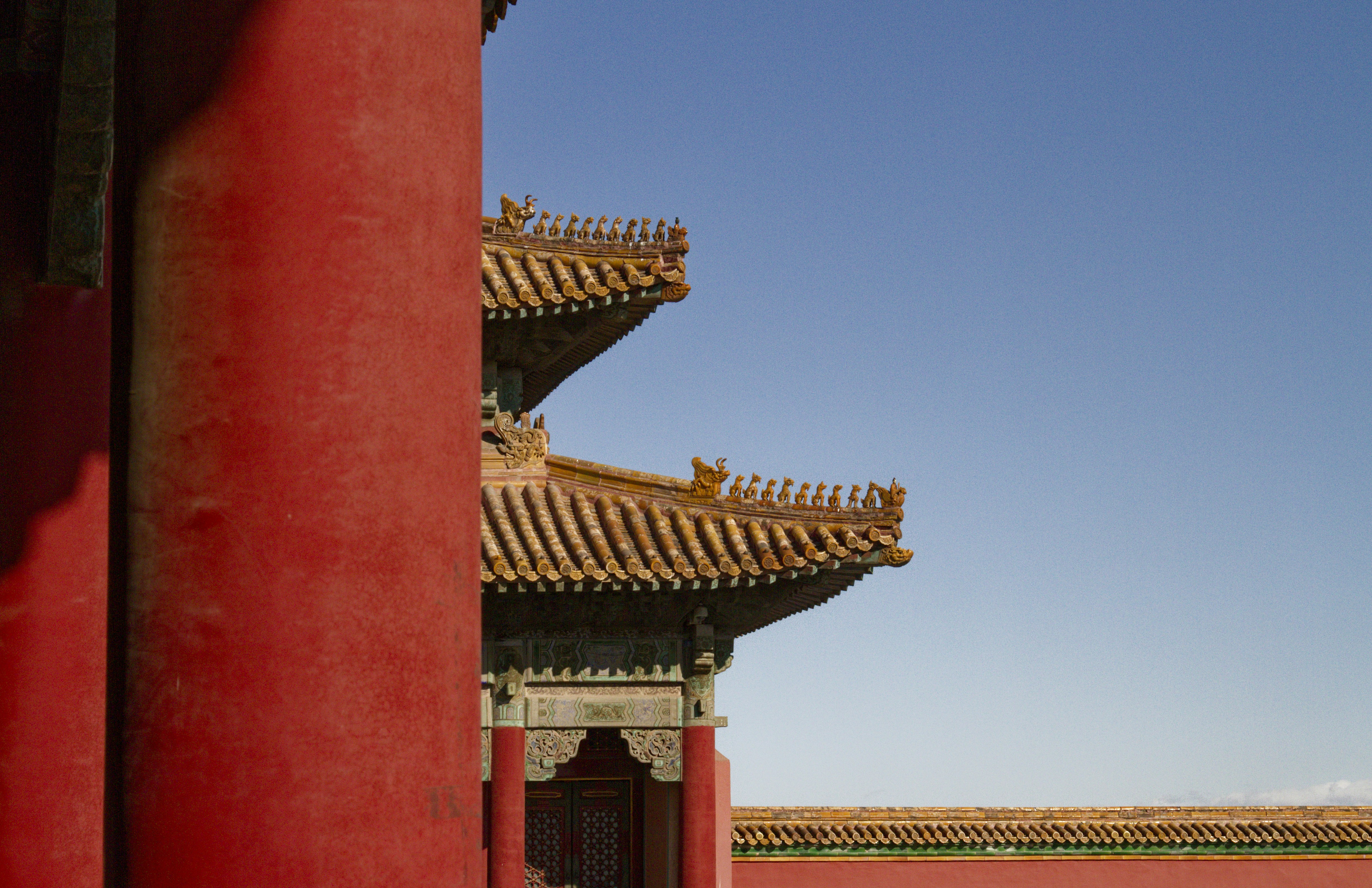 a tall red building with a sky in the background