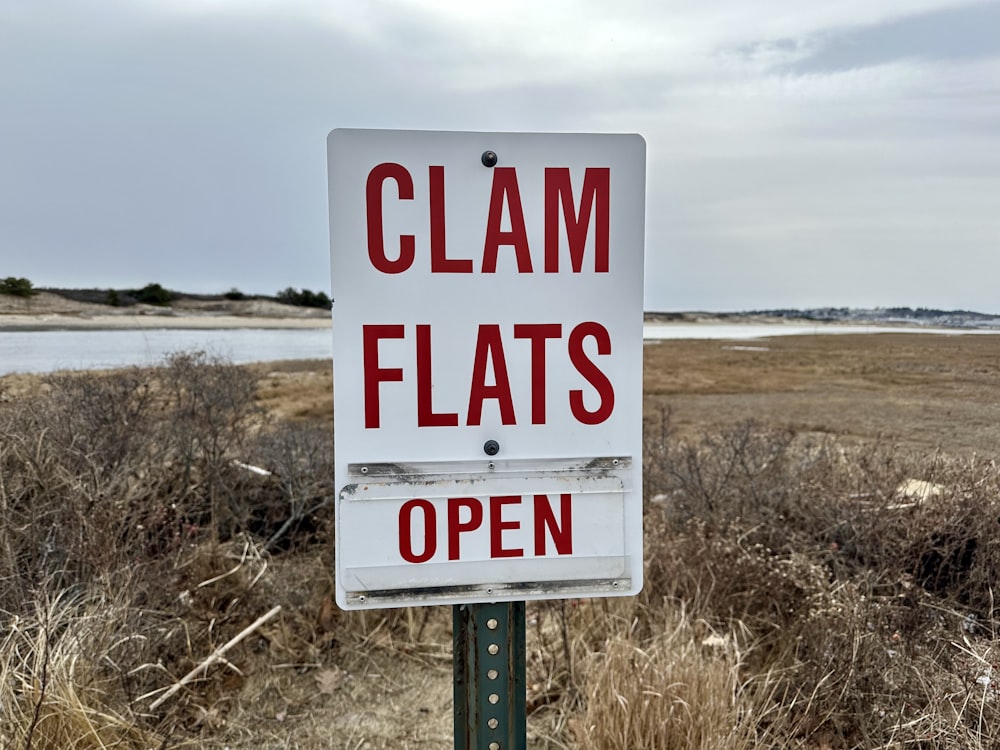 a sign that says clam flats open