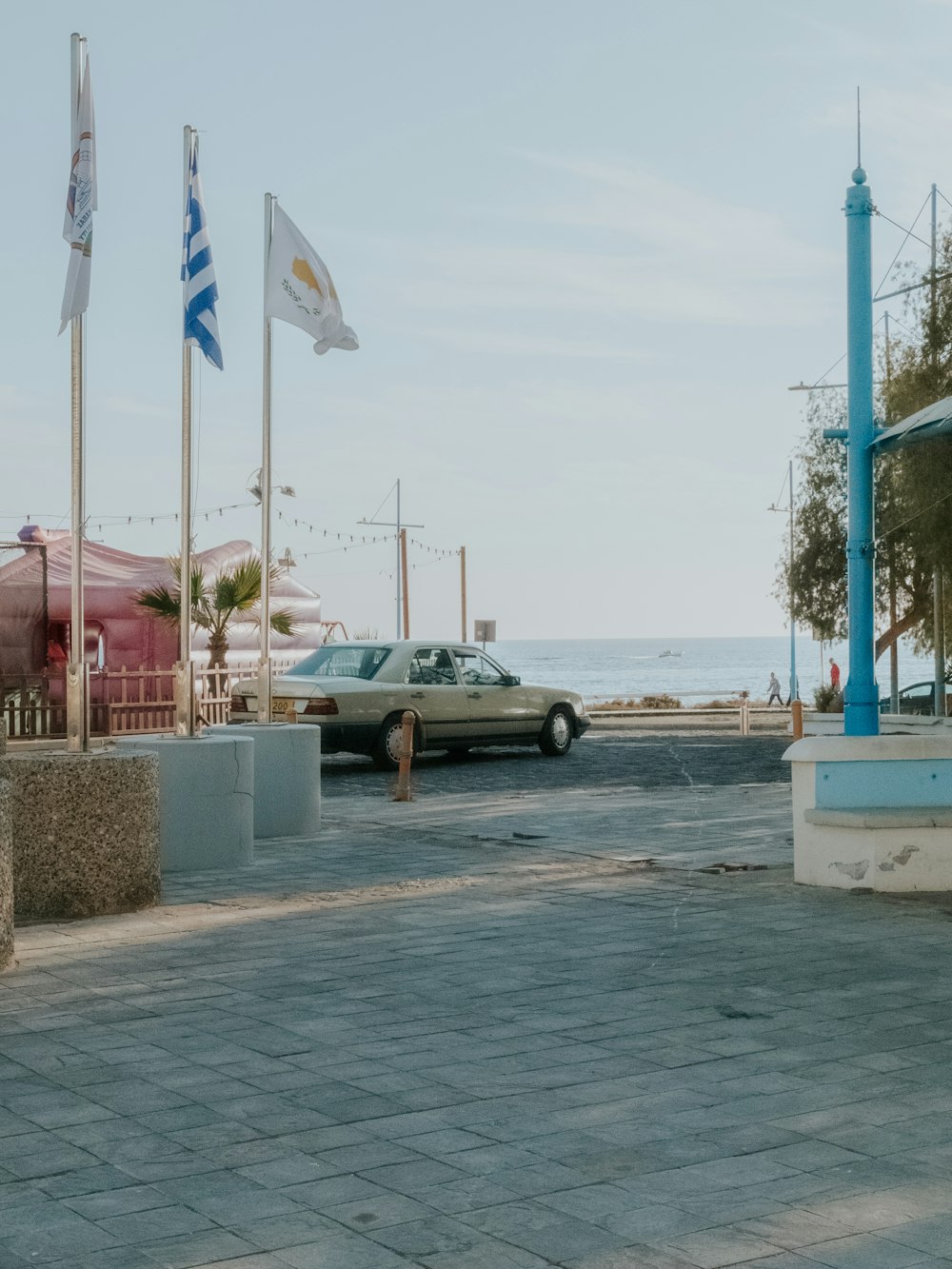 a car parked in a parking lot next to the ocean