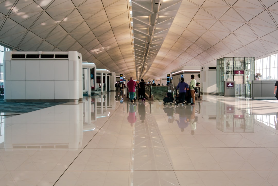 a group of people walking through an airport,