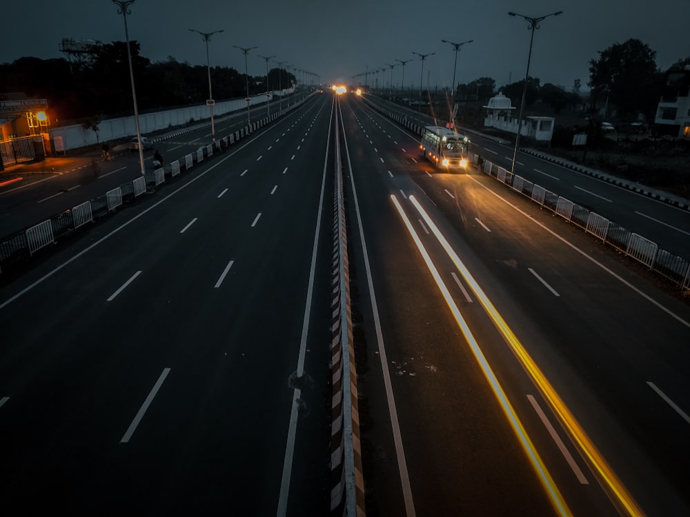 a truck driving down a highway at night