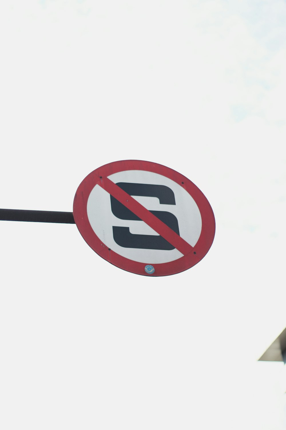 a no parking sign hanging off the side of a pole