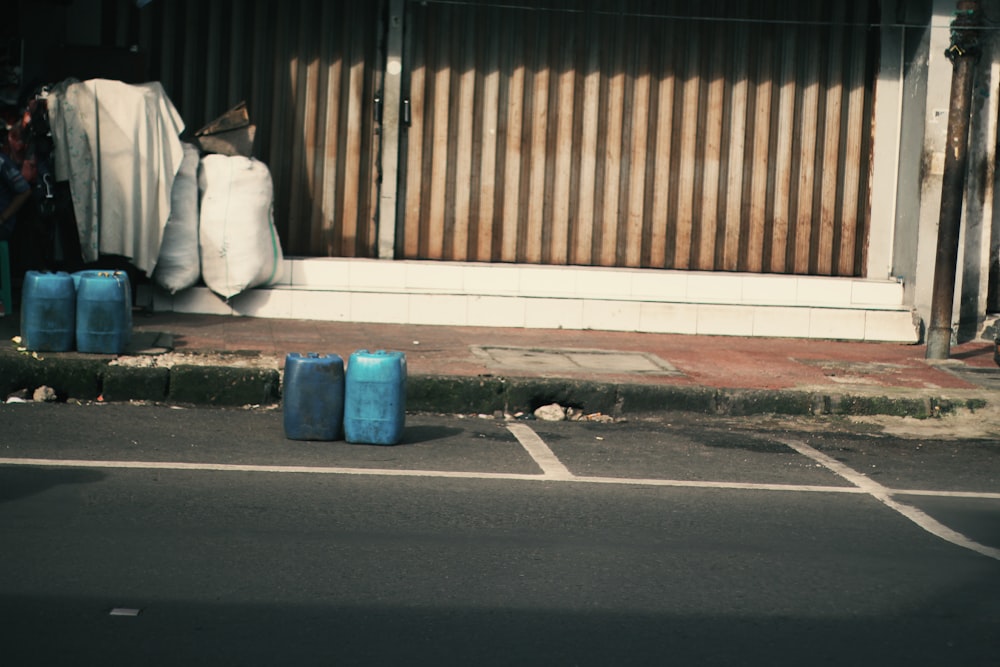 a couple of blue suitcases sitting on the side of a road