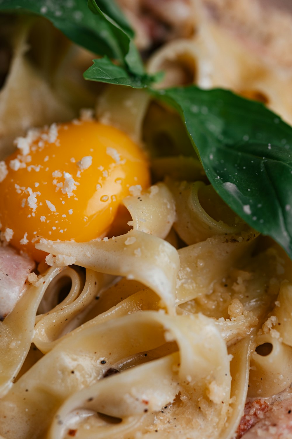 a close up of a plate of food with pasta and an orange