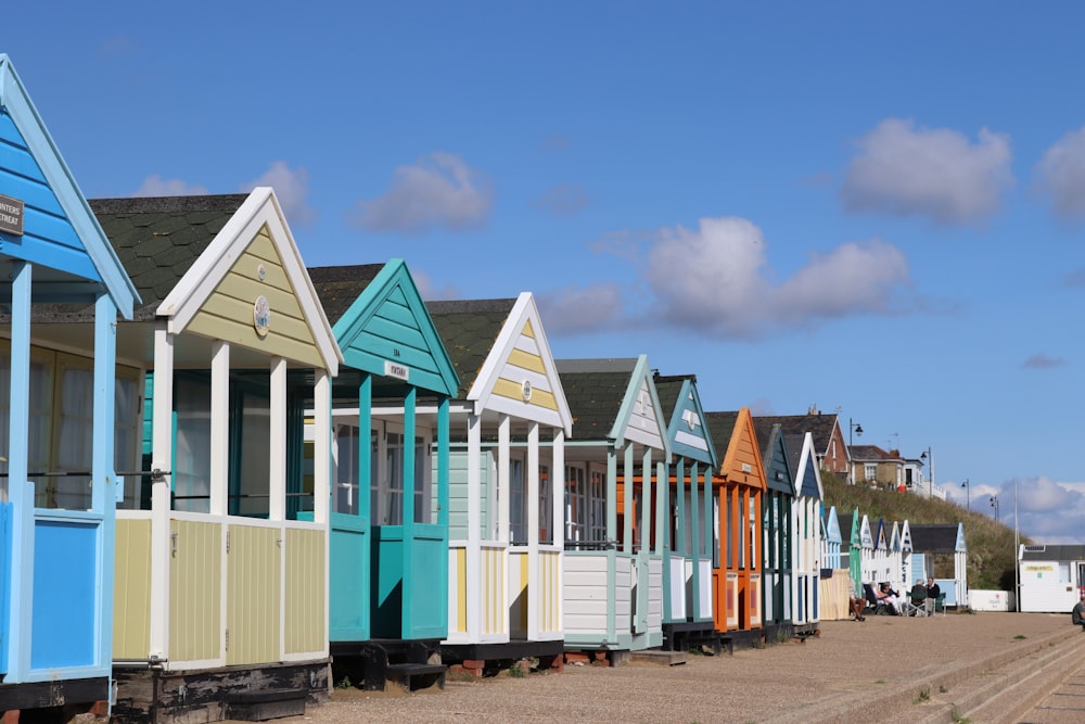 a row of colorful beach huts sitting next to each other