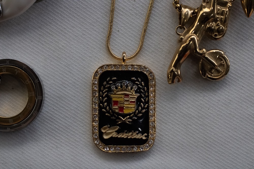 a gold necklace with a coat of arms on it