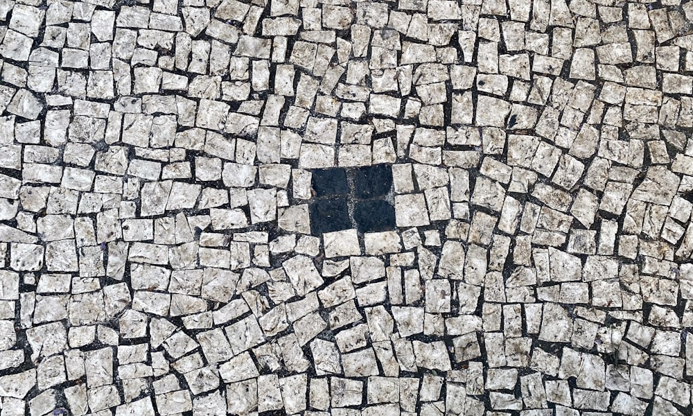 a black square in the middle of a cobblestone street