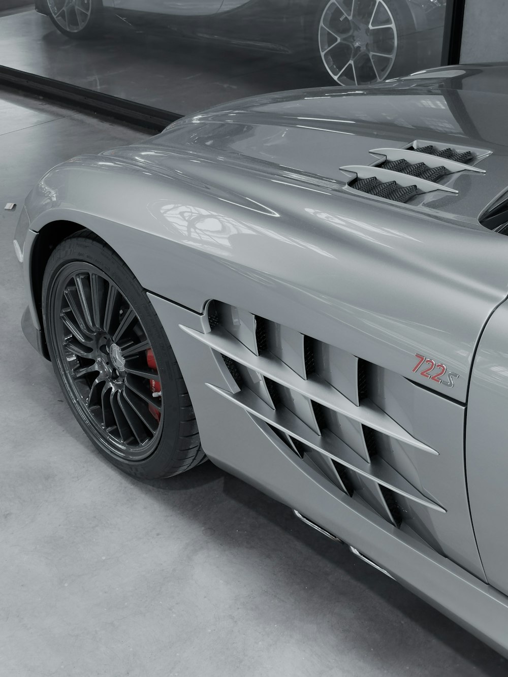 a silver sports car parked in a garage