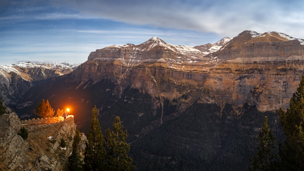 a view of a mountain range with a light at the end of it