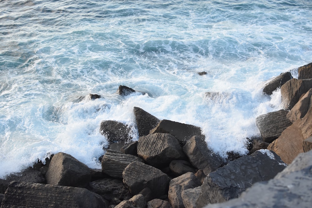 a rocky shore with waves crashing against the rocks