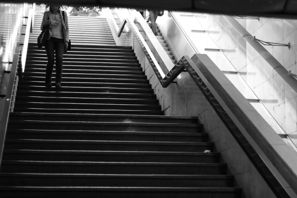 a woman walking down a flight of stairs