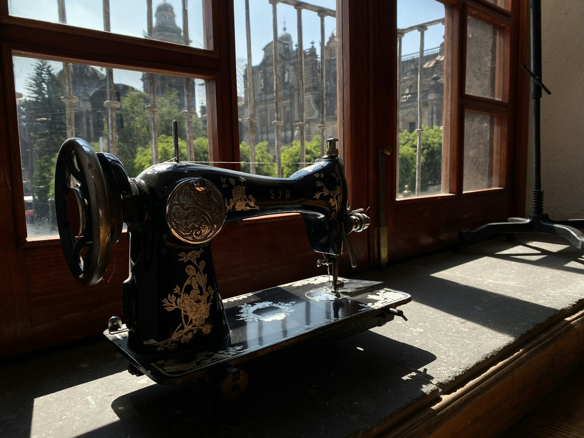 a sewing machine sitting in front of a window