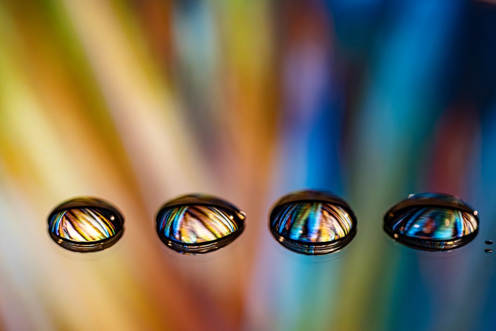 three drops of water sitting on top of a table