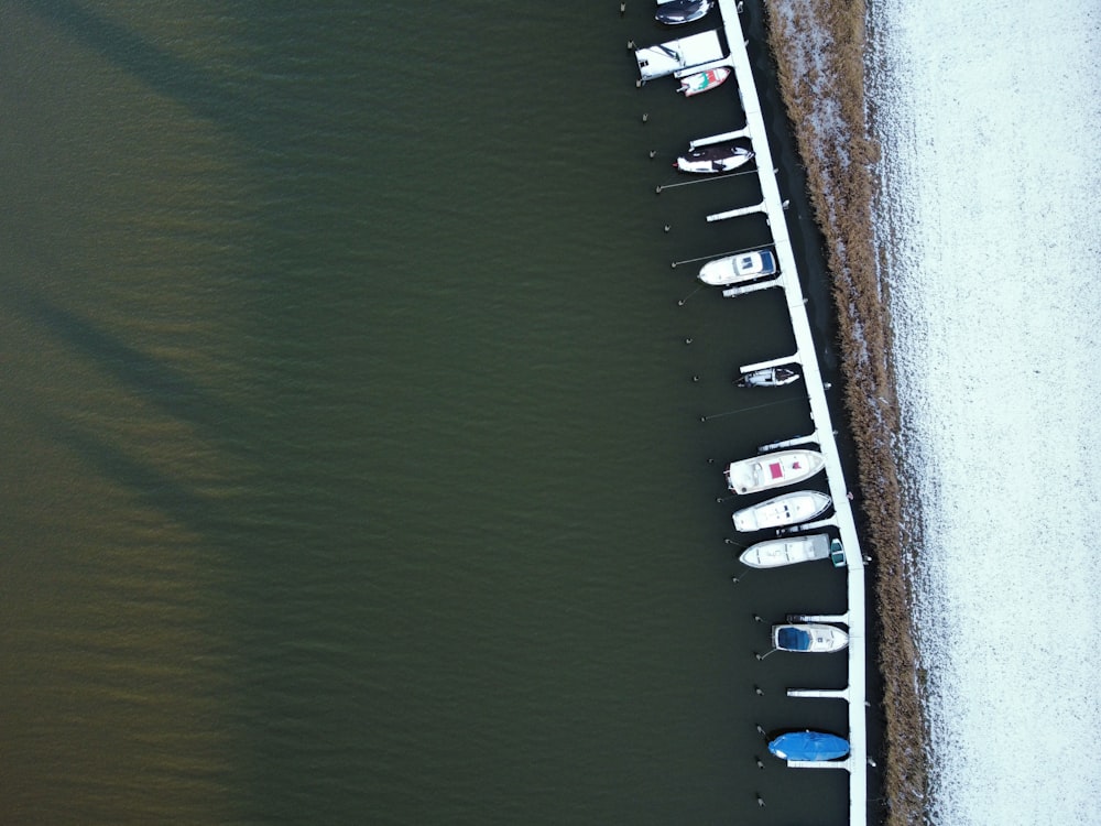 a row of boats sitting on top of a body of water