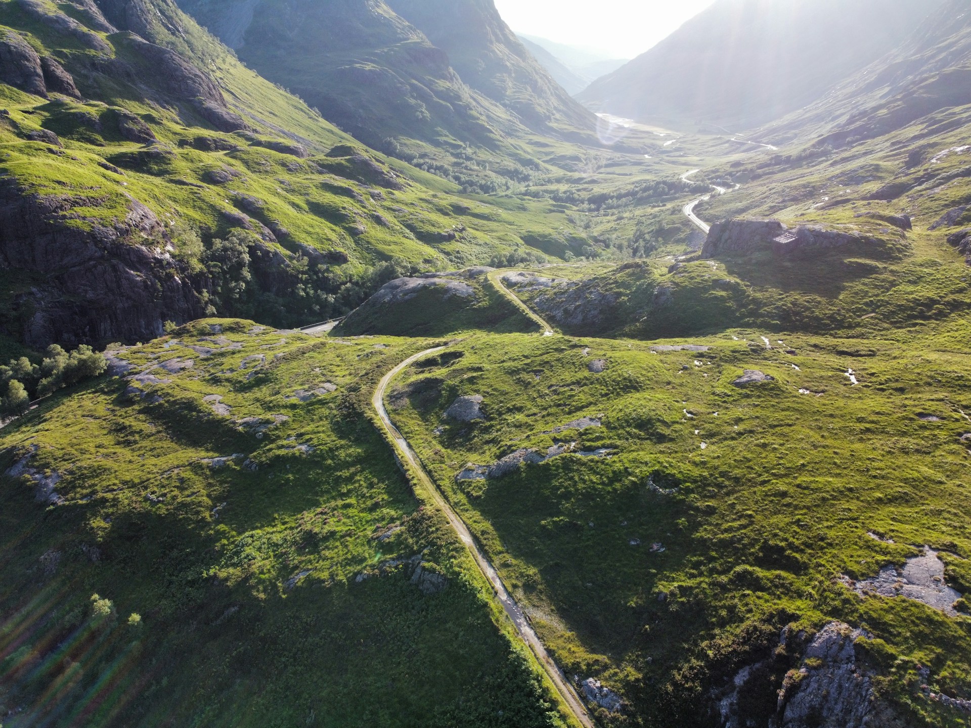 an aerial view of a winding road in the mountains