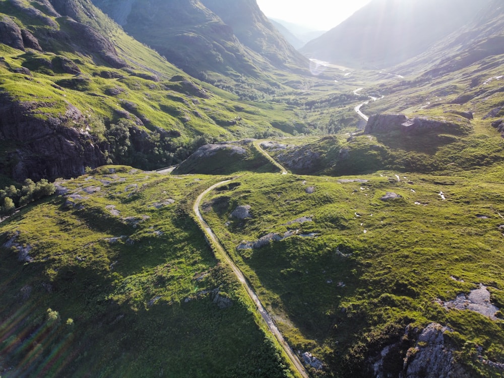 an aerial view of a winding road in the mountains