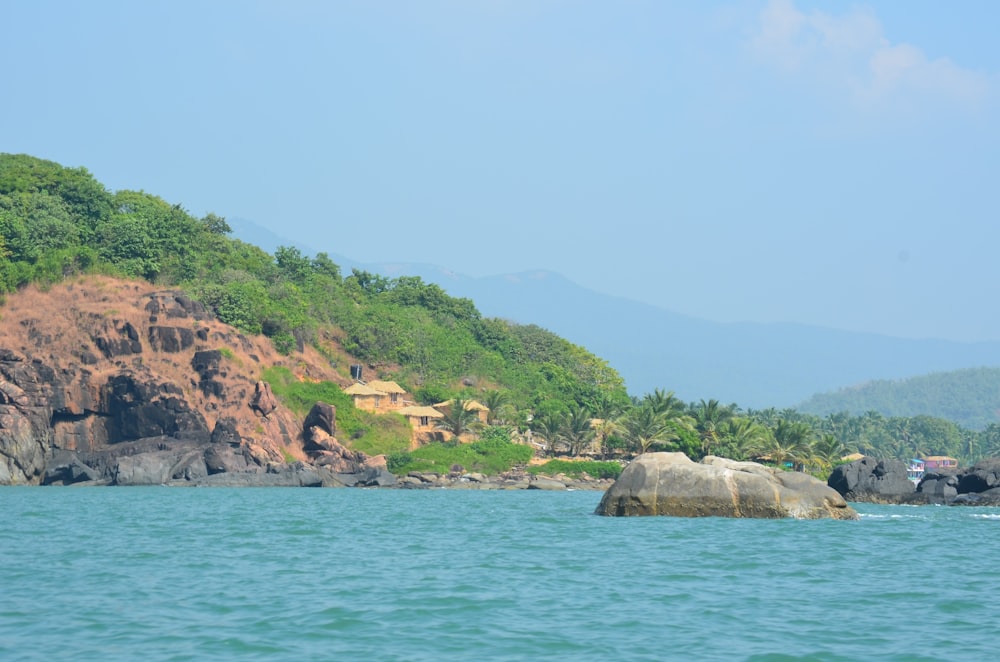 a large rock in the middle of a body of water