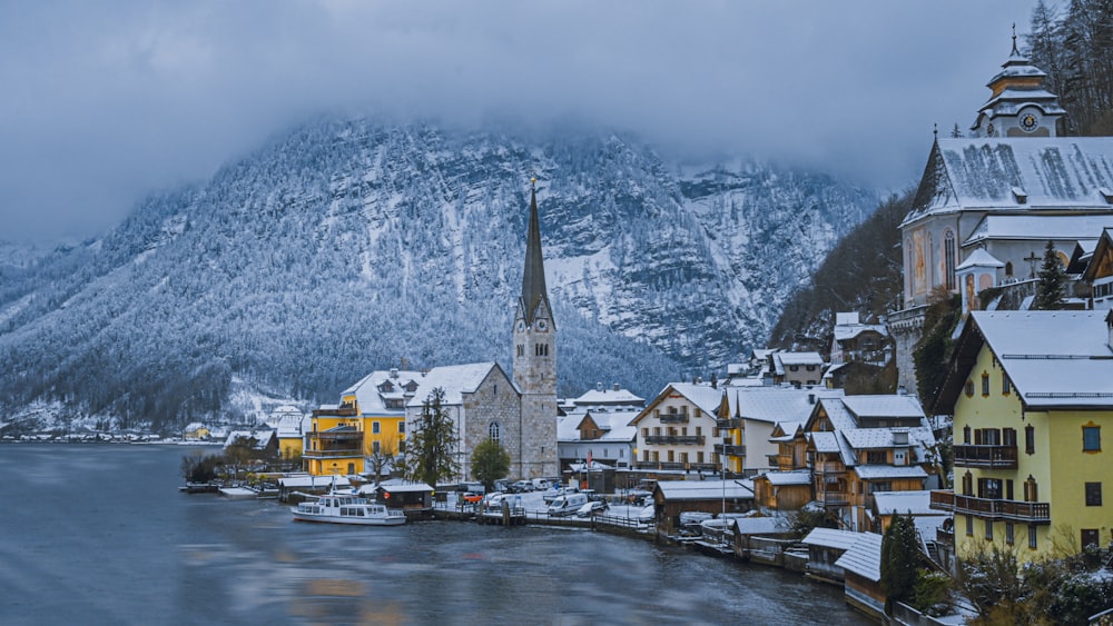 a snowy village with a church in the middle of it
