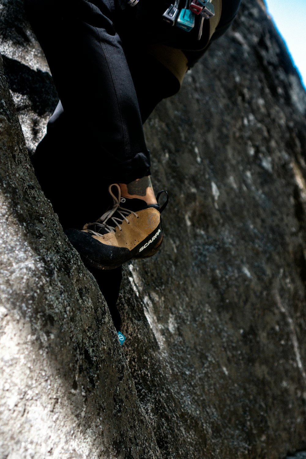 a man climbing up the side of a mountain