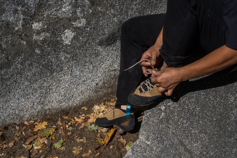 a person sitting on the ground with their shoes on