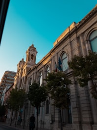 a man walking down a street next to a tall building