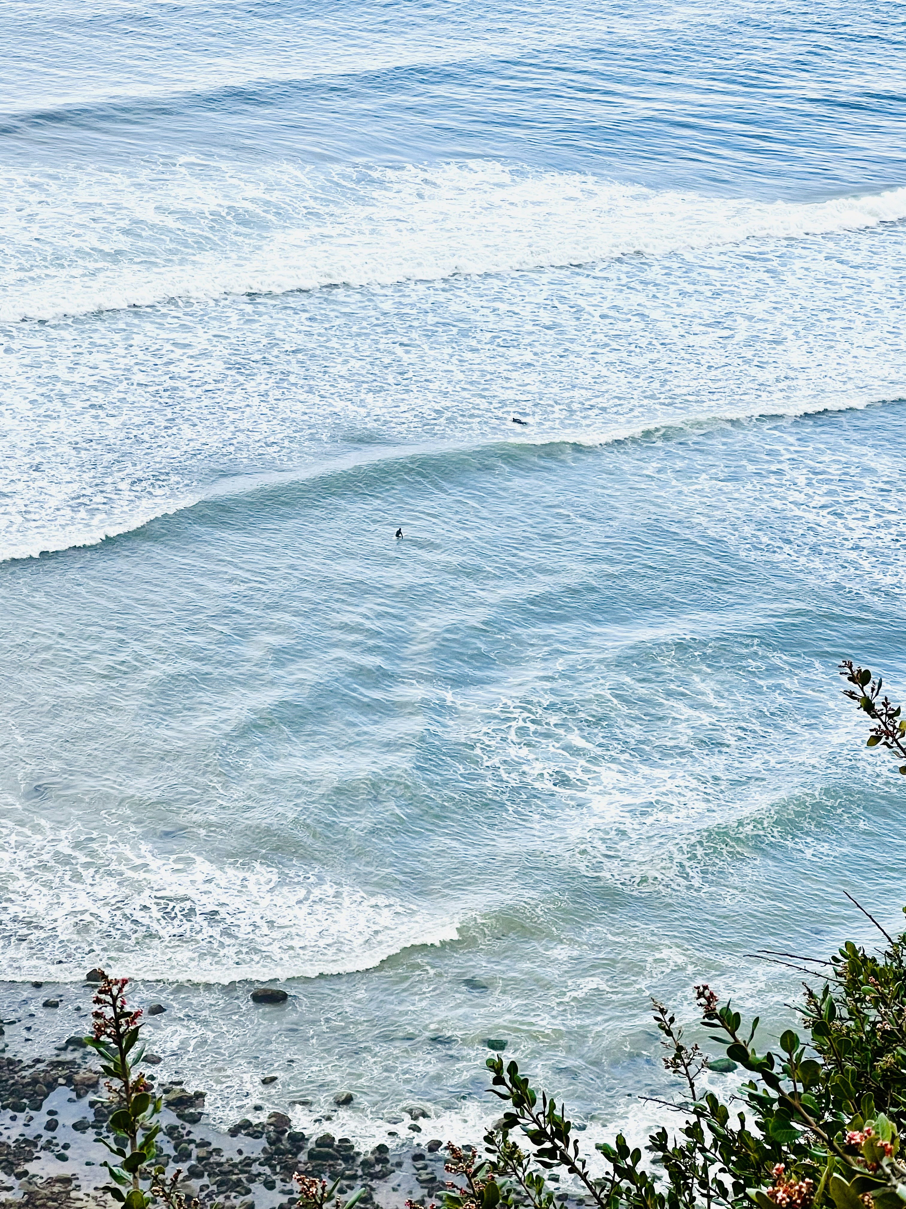a man riding a wave on top of a surfboard