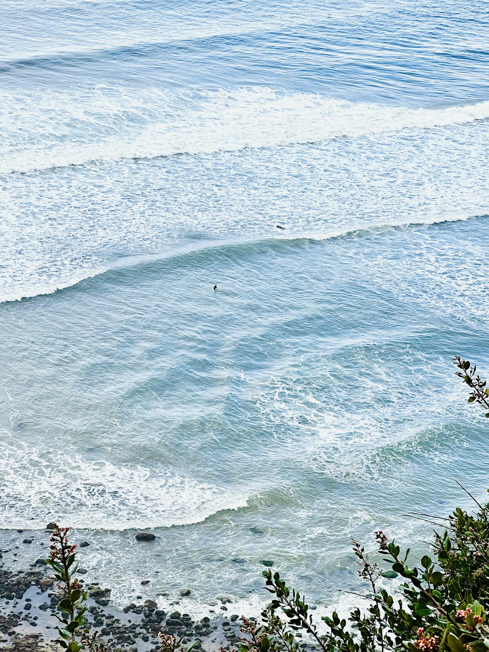 a man riding a wave on top of a surfboard