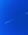 a jet flying through a blue sky with a contrail