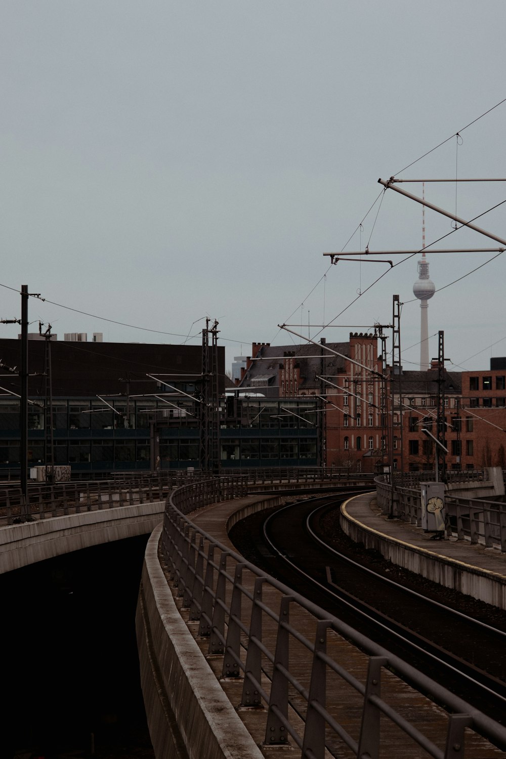 a train traveling through a train station next to tall buildings