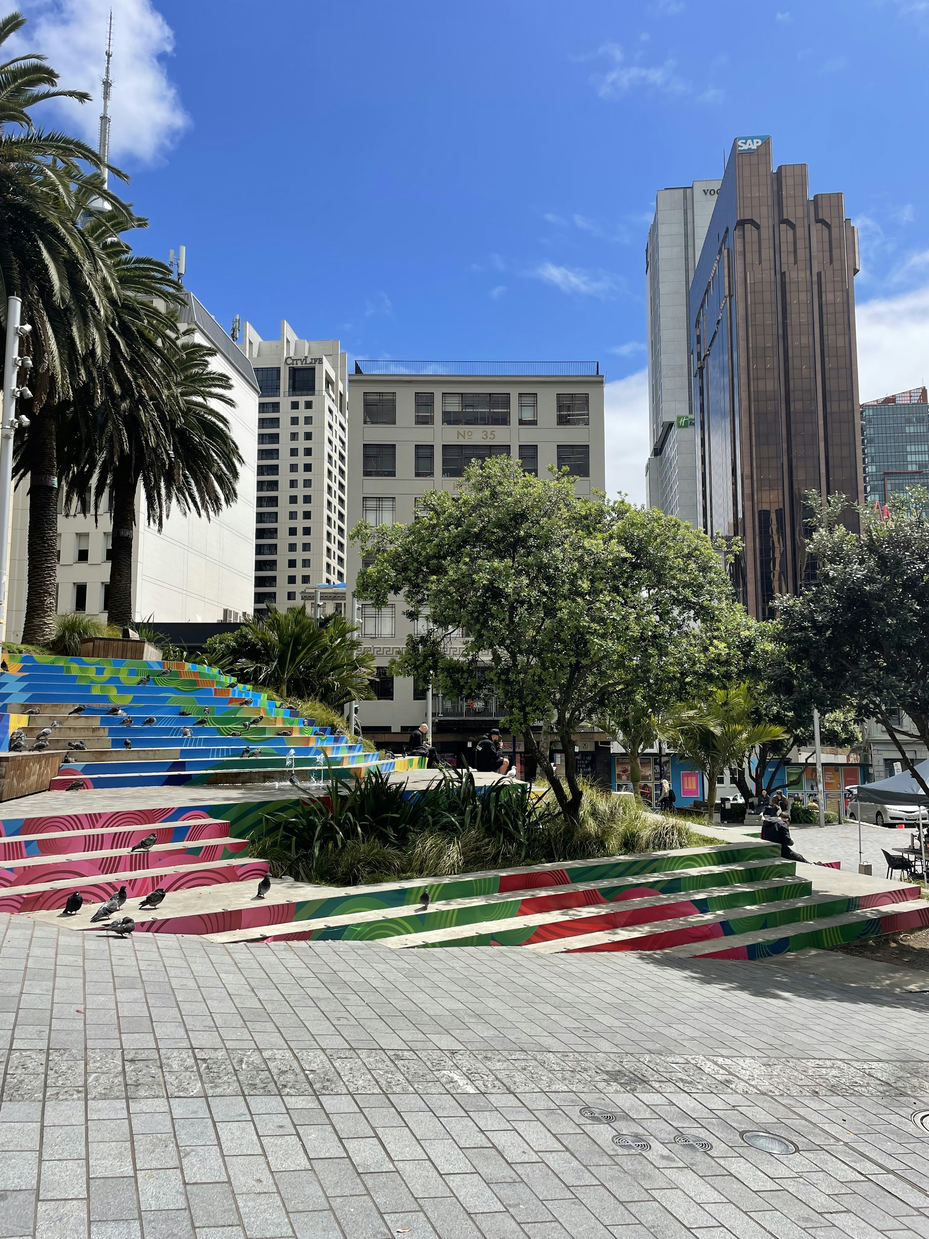 a colorful set of stairs with palm trees in the background