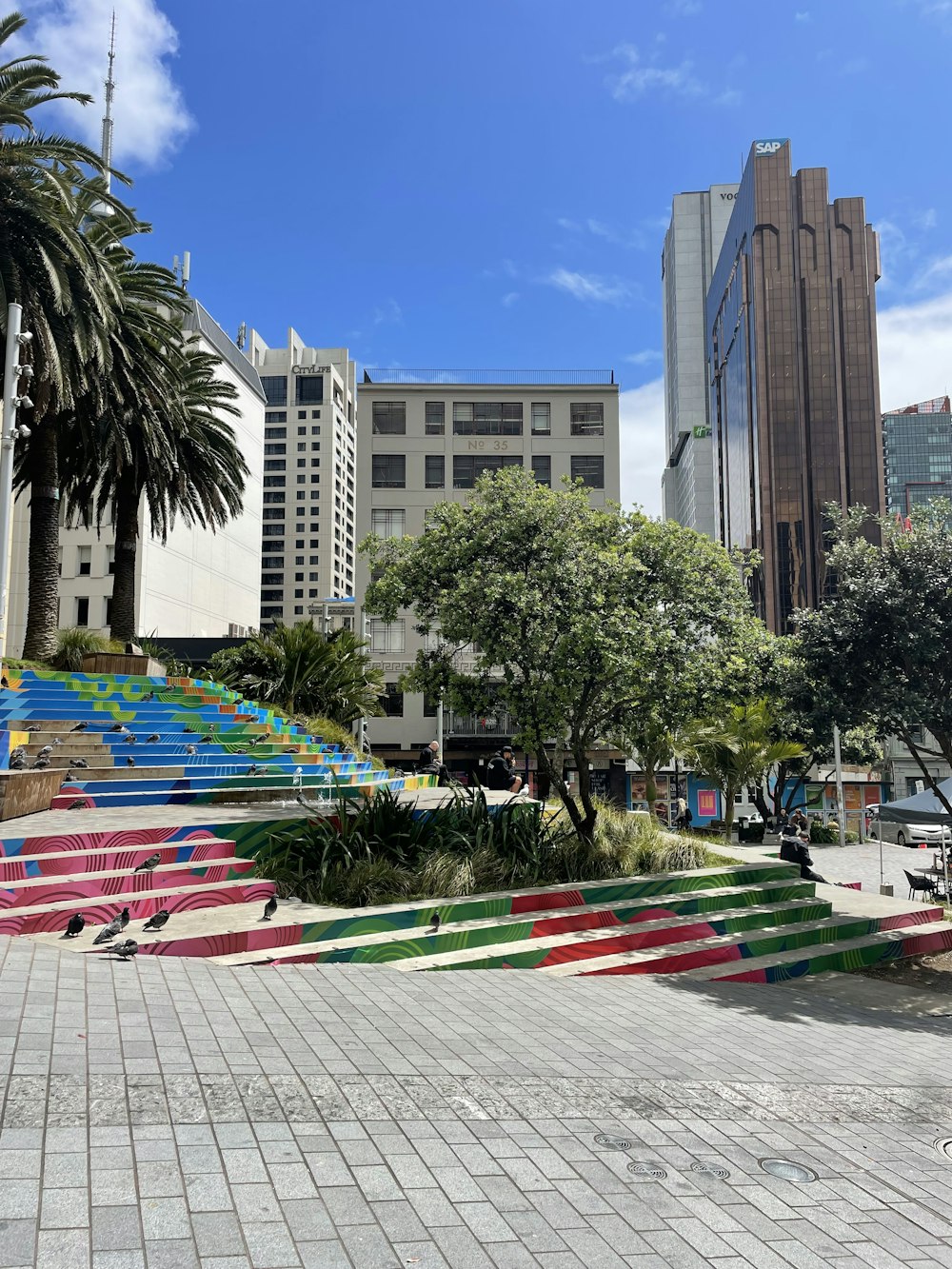 a colorful set of stairs with palm trees in the background