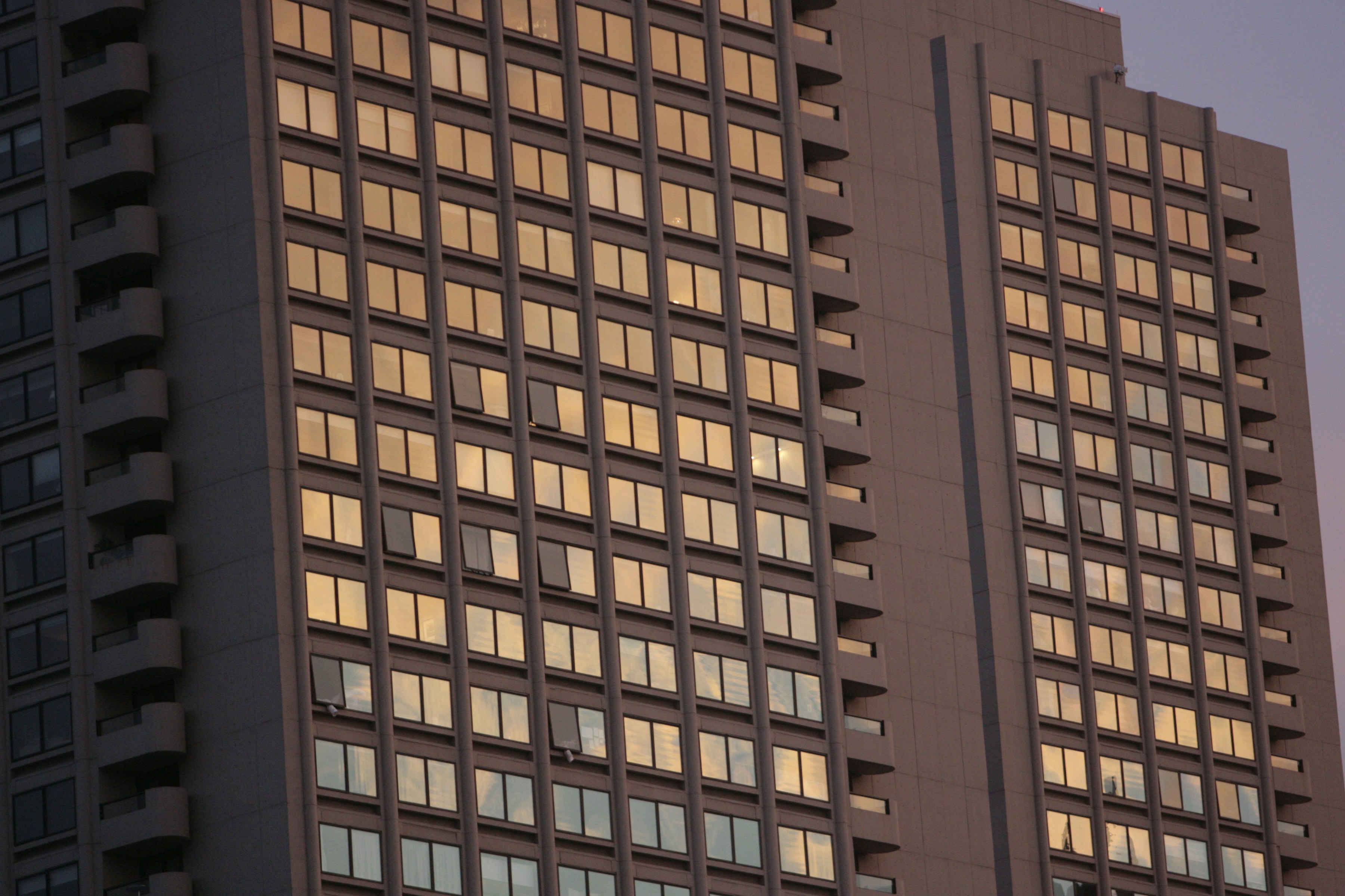 Modern South African home exterior at sunset, warm orange sky, clean architecture — bright warm environment