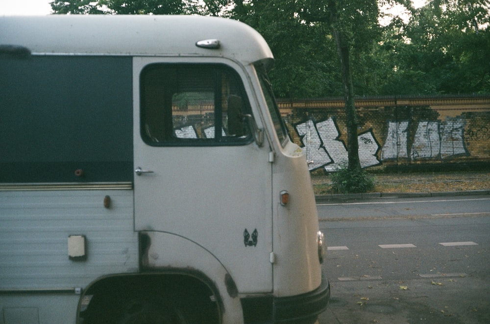 an old bus parked on the side of the road