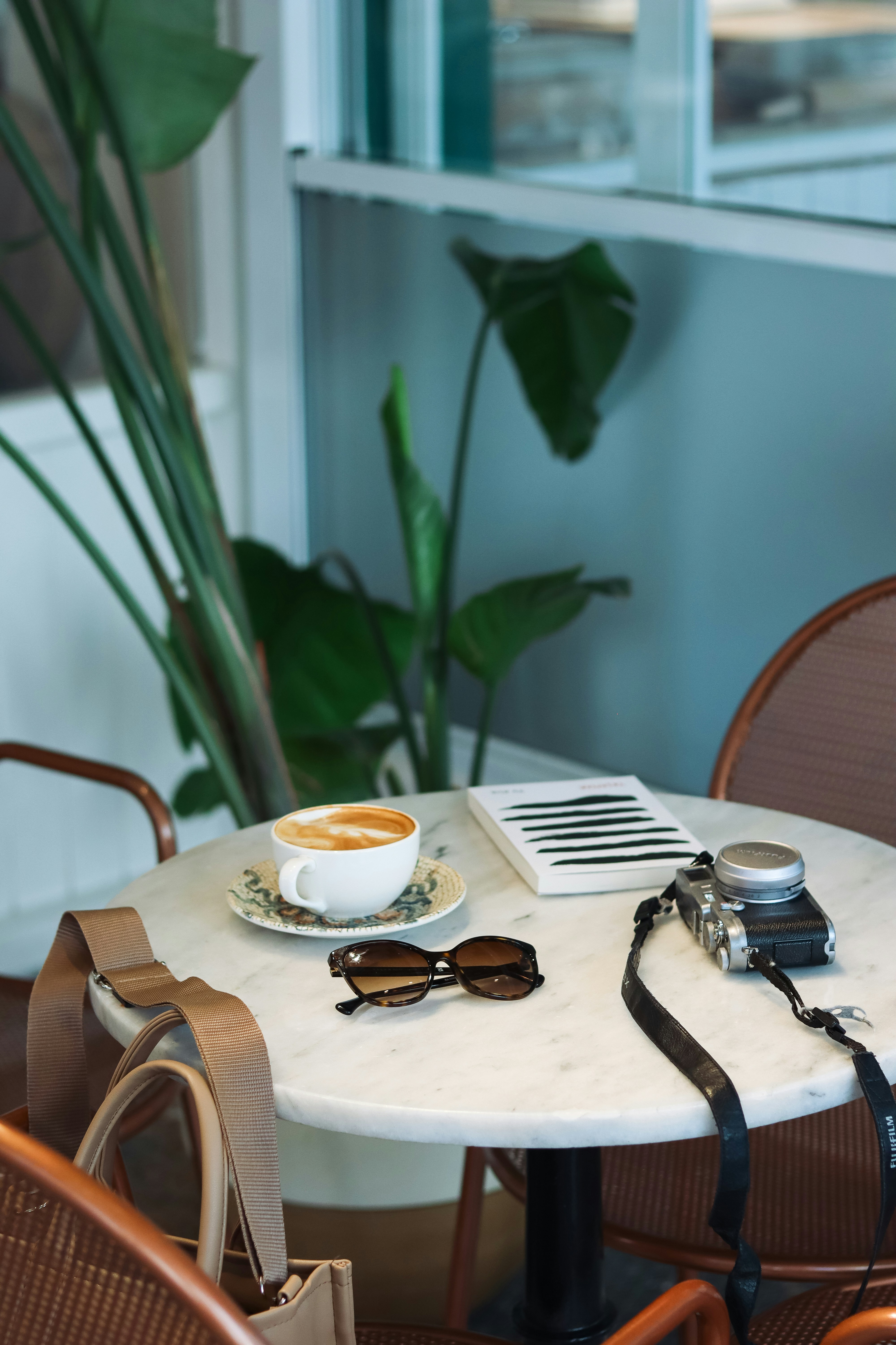 a white table topped with a cup of coffee