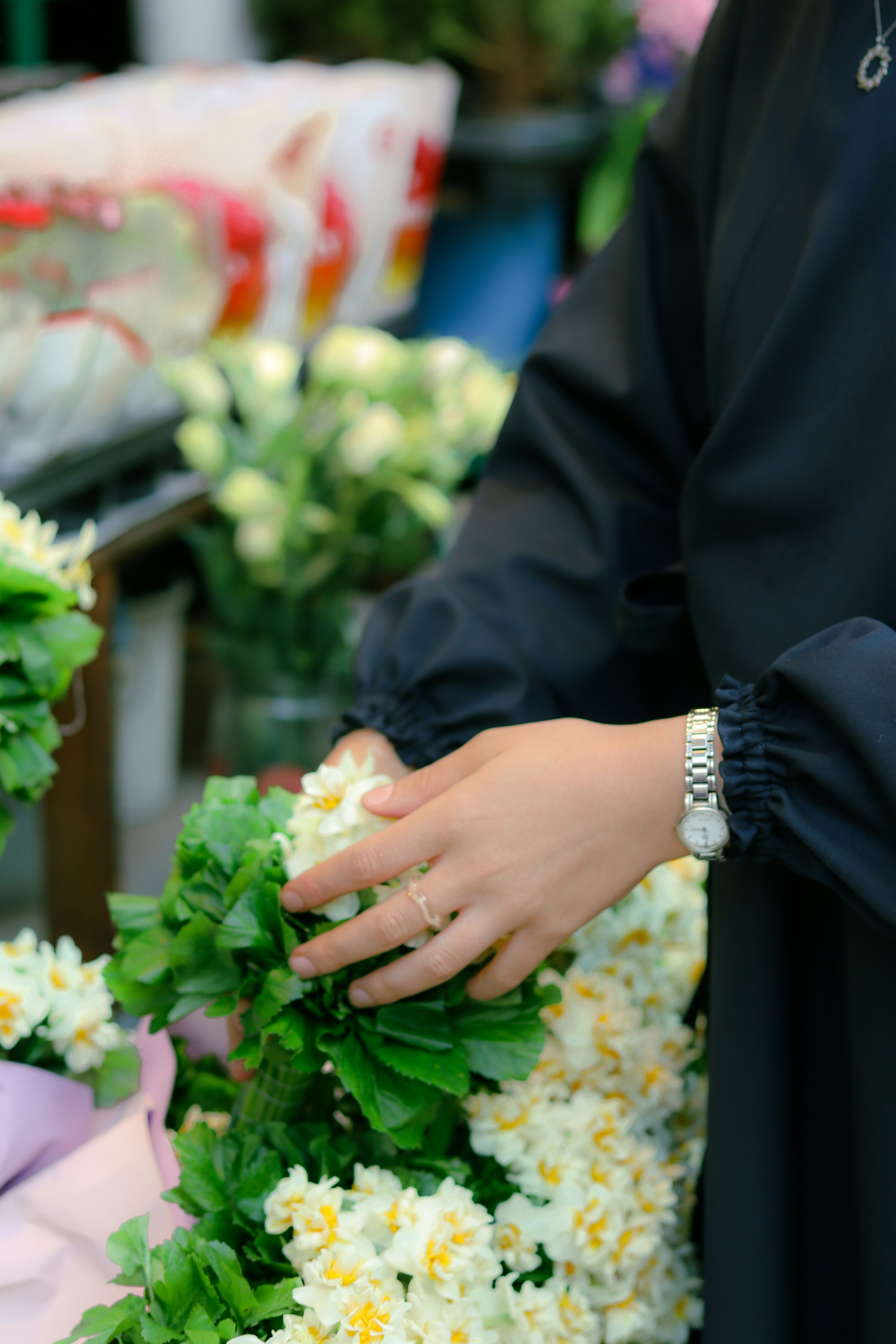 a woman holding a bunch of flowers in her hands