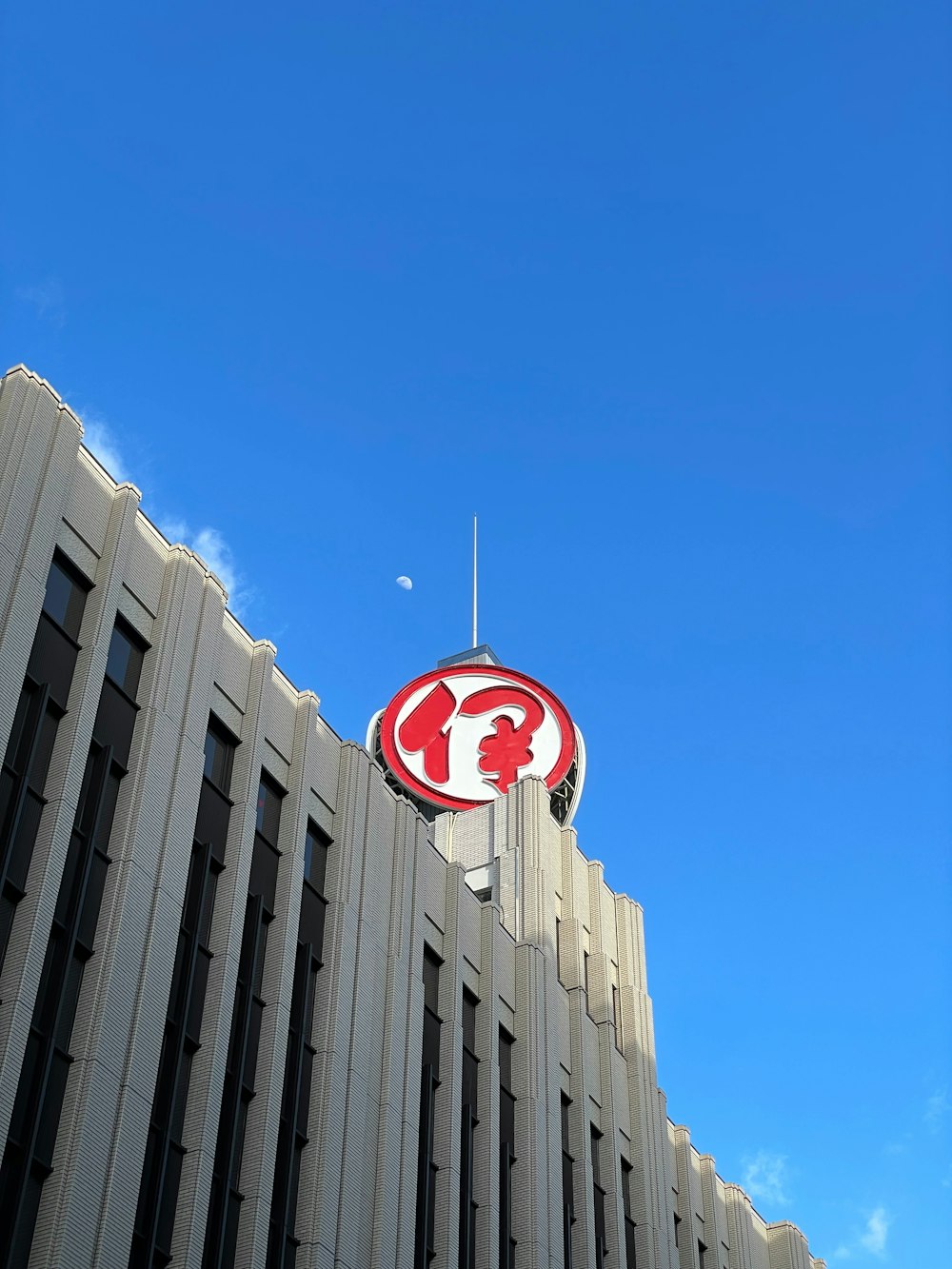 a red and white sign on top of a building