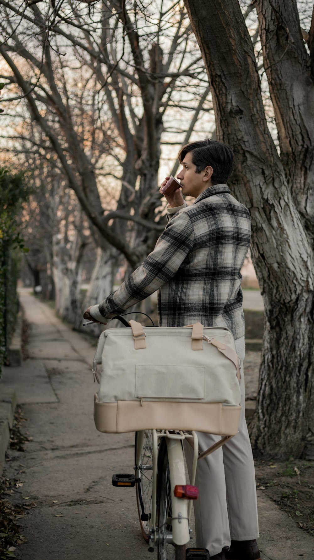 a man riding a bike with a bag on the back of it